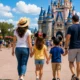Family walking toward Cinderella Castle at Disney World while enjoying a magical vacation. More SEO-focused